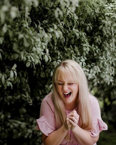 Steph laughing in the woods